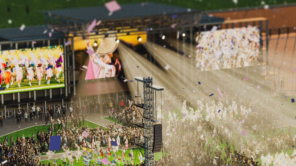 大型のステージで祝祭を楽しむ人々が集まる様子。背景には、色とりどりの演出が施されたスクリーンと光の演出が見え、賑やかな雰囲気が漂っている。